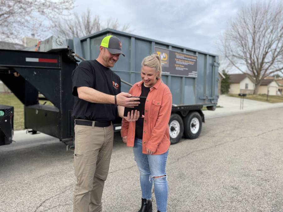 A Treasure Valley Disposal employee helping a customer with pricing